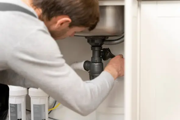 man fixing frequent clogs