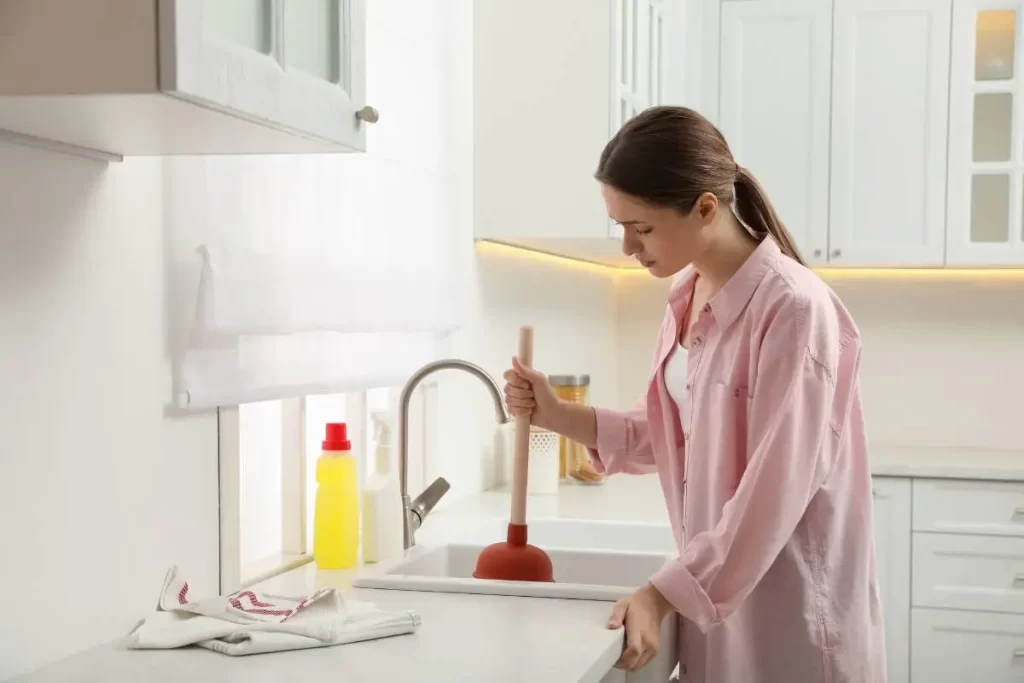 unblocking a sink with a plunger