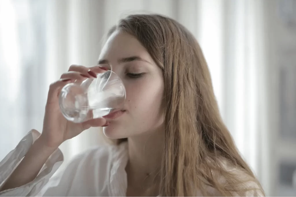 a woman drinking tap water